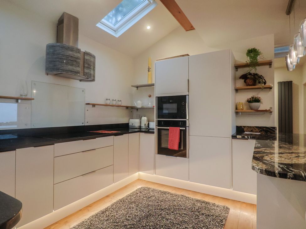 A kitchen with cabinets and appliances at Devona in Beer