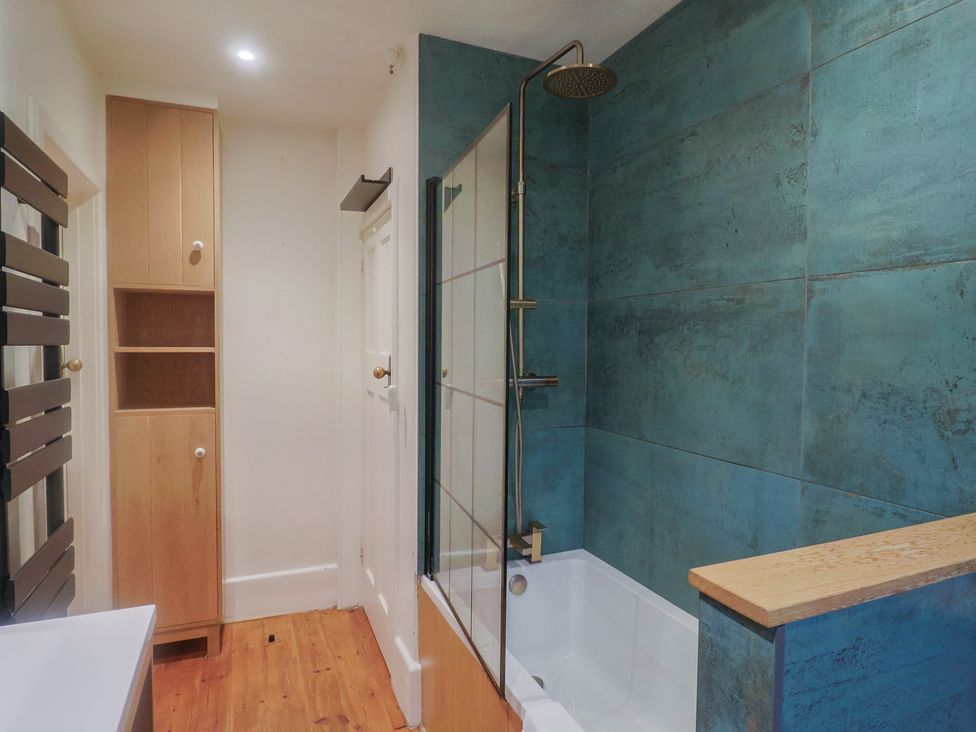 A bathroom with a bath and shower at Devona in Beer