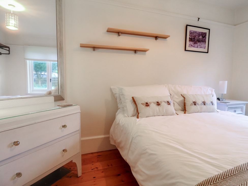 A bedroom with a bed and pillows at Devona in Beer