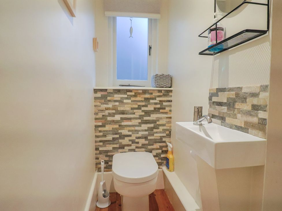 A bathroom with a toilet and sink at Devona in Beer