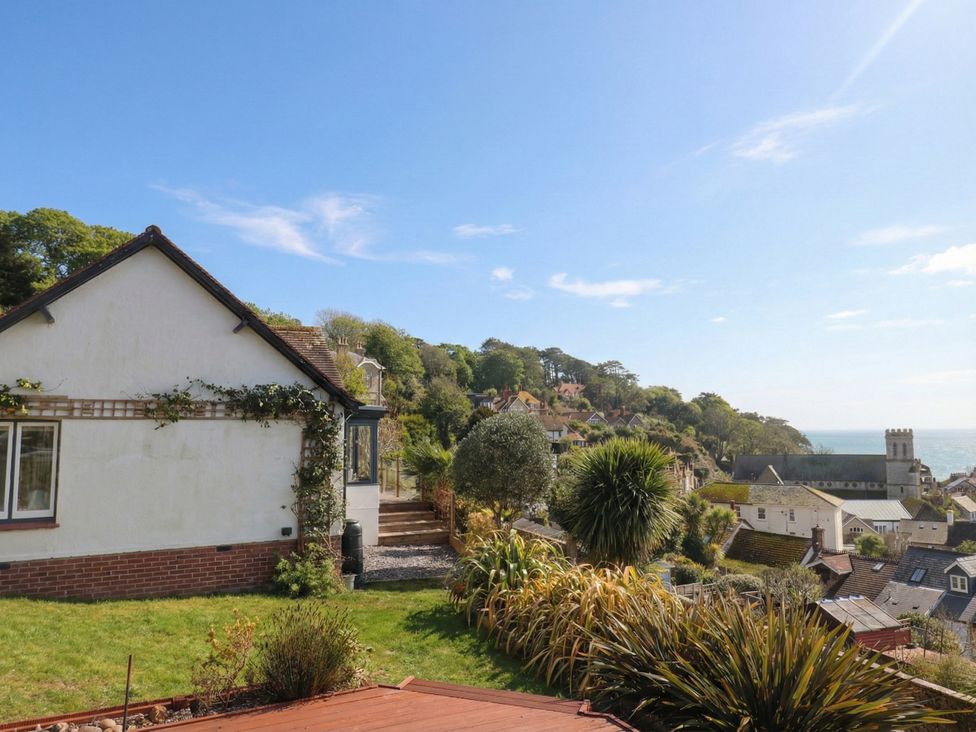 A view of a house and garden overlooking the sea at Devona, Beer