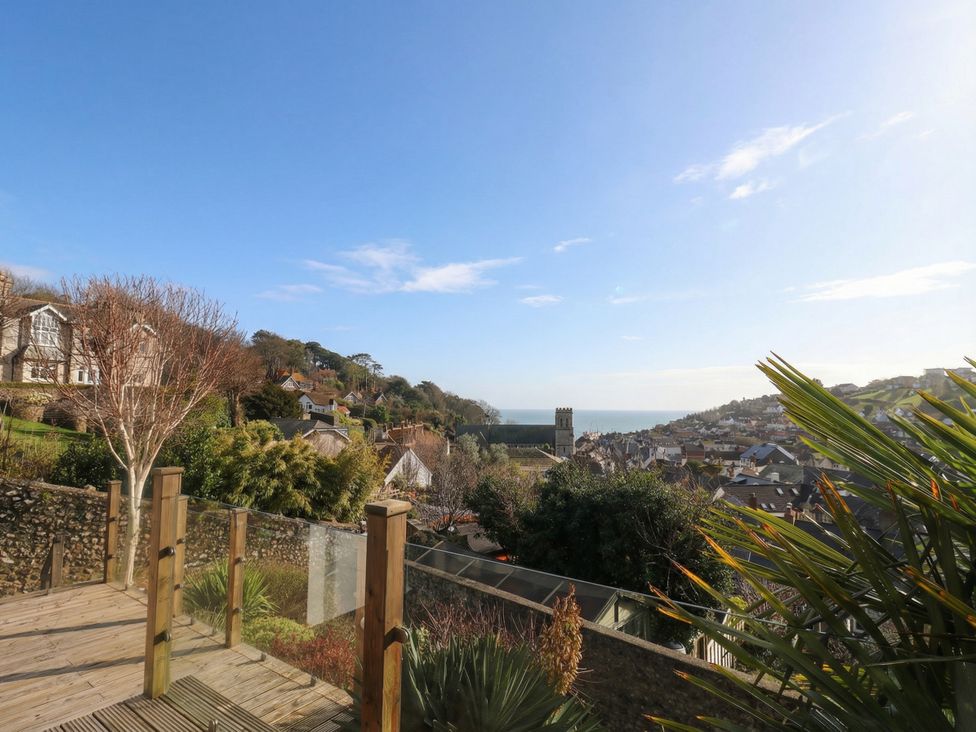 A view of houses and ocean from a deck in Devona Beer