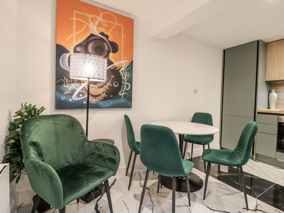 A dining room with a table and chairs at 2A Ruby Street, Southwark, London