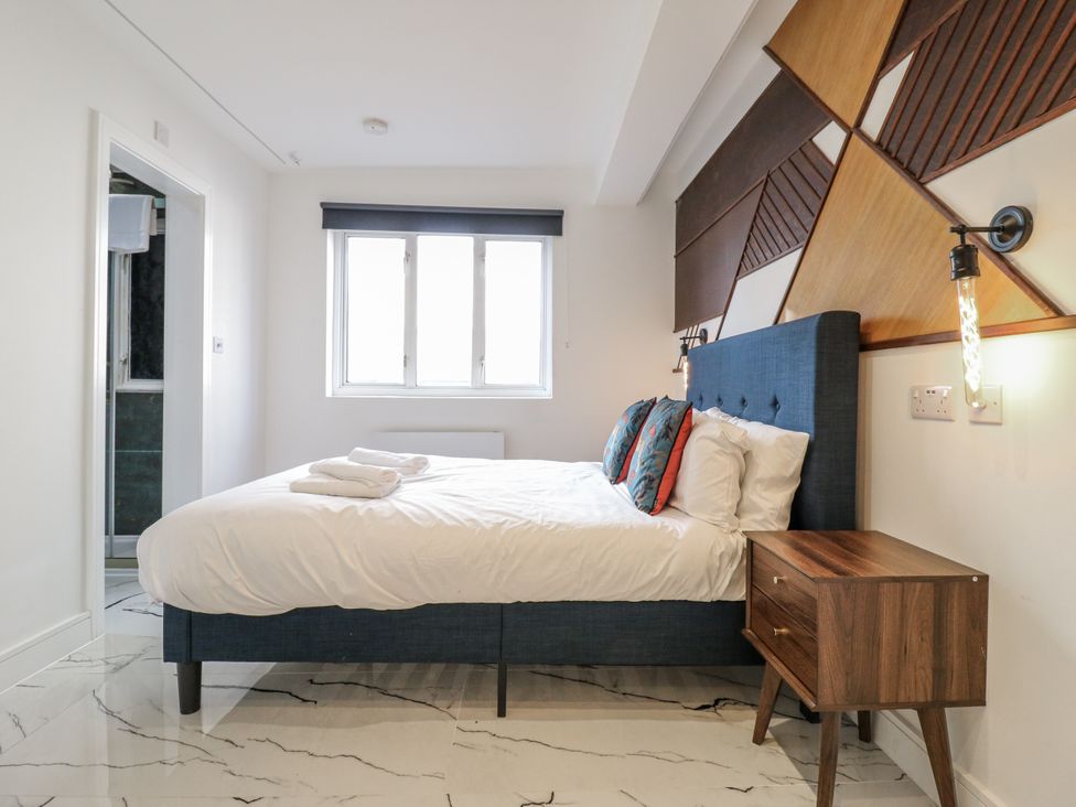 A bedroom with a bed and bedside table at 2A Ruby Street Southwark, London