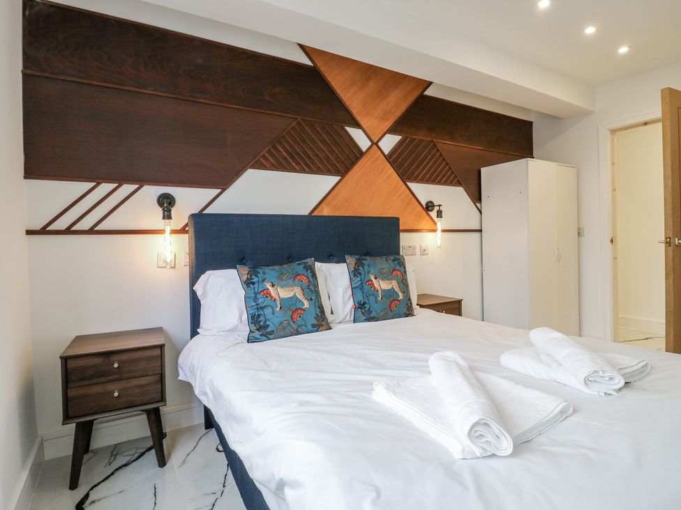 A bedroom with a bed and nightstand at 2A Ruby Street Southwark, London
