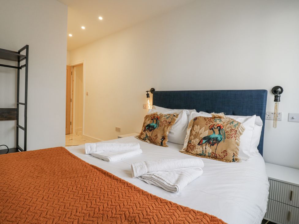A bedroom with a bed and pillows at 2A Ruby Street in Southwark, London