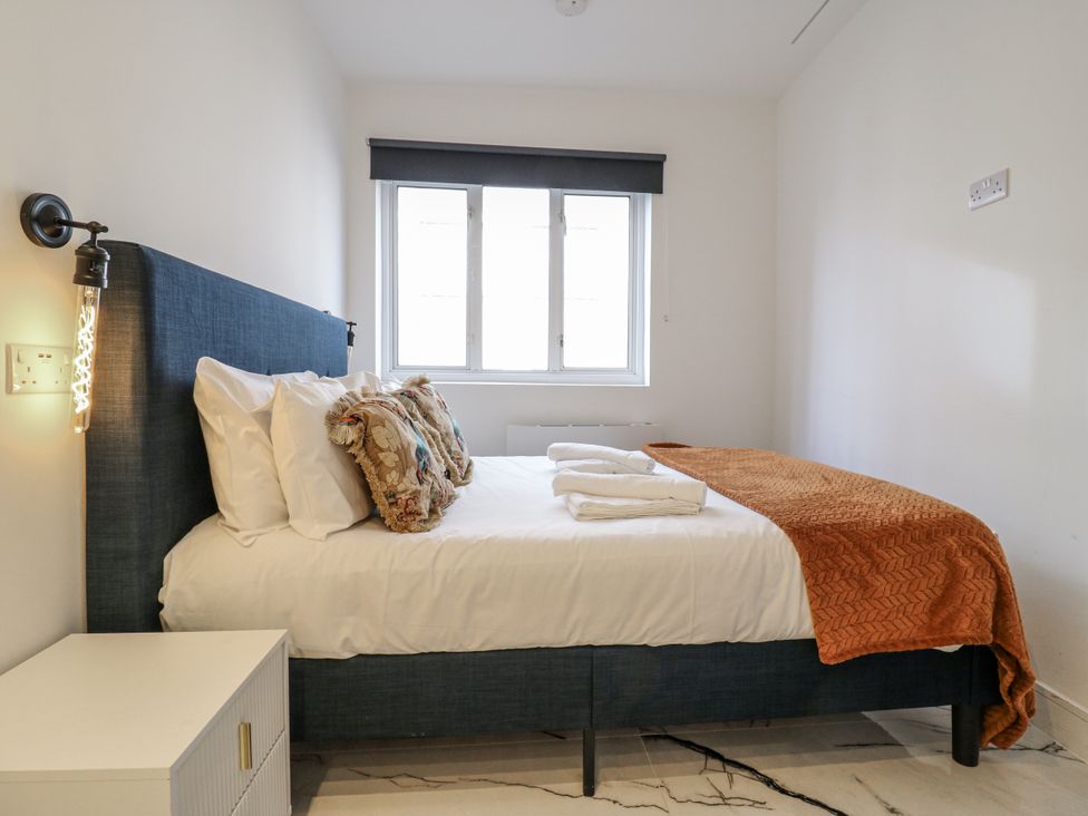 A bedroom with a bed and nightstand at 2A Ruby Street, Southwark, London