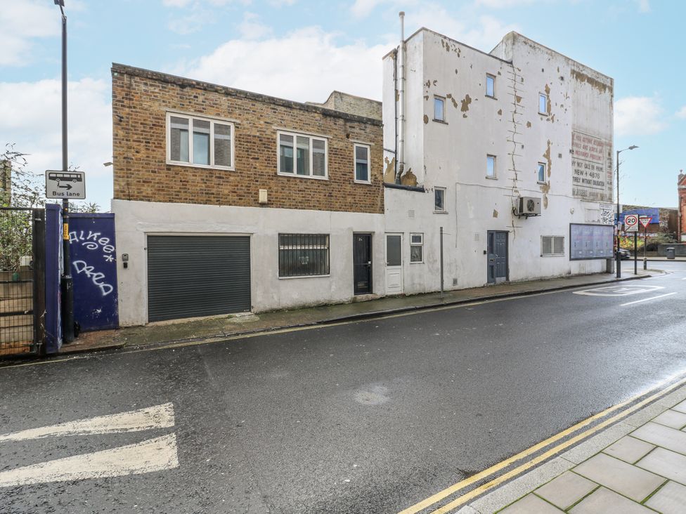 A building with windows and a garage at 2A Ruby Street Southwark, London