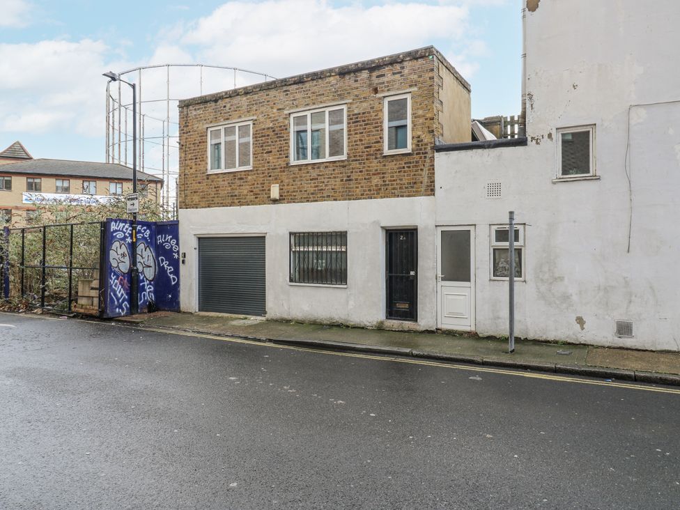 A building with garage door and front door at 2A Ruby Street Southwark London