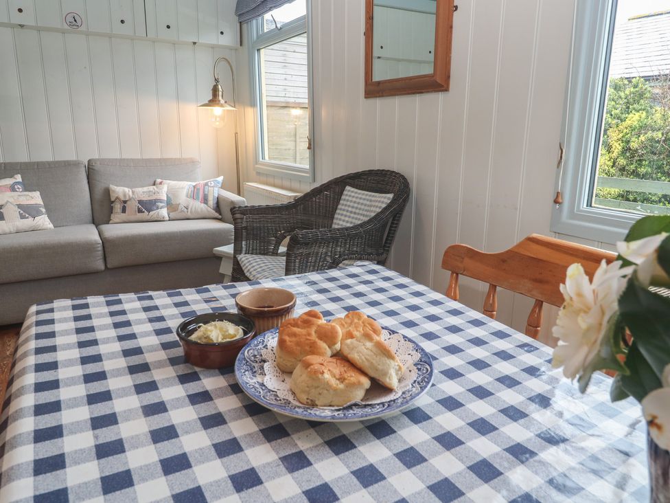 A living room with a sofa and biscuits on a table at Pleasans in Hayle