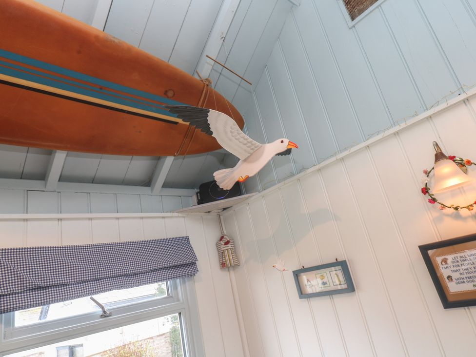 An indoor photo featuring a model bird and a boat at Pleasans in Hayle
