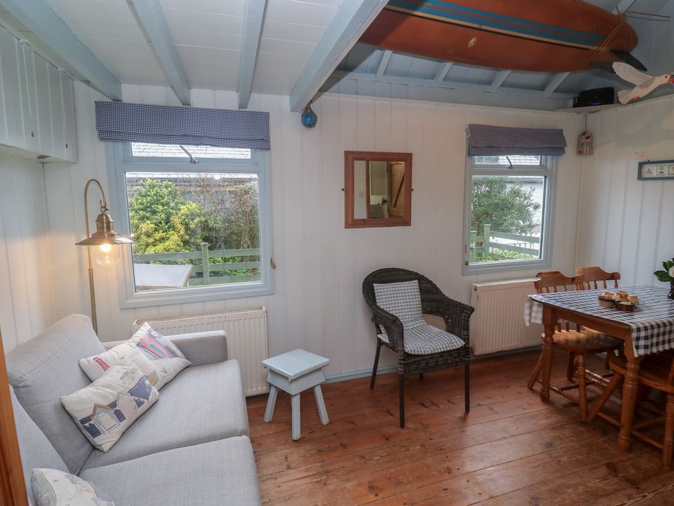 A living room with a sofa and dining table at Pleasans in Hayle