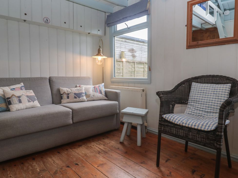 A snug with a sofa and a table at Pleasans in Hayle