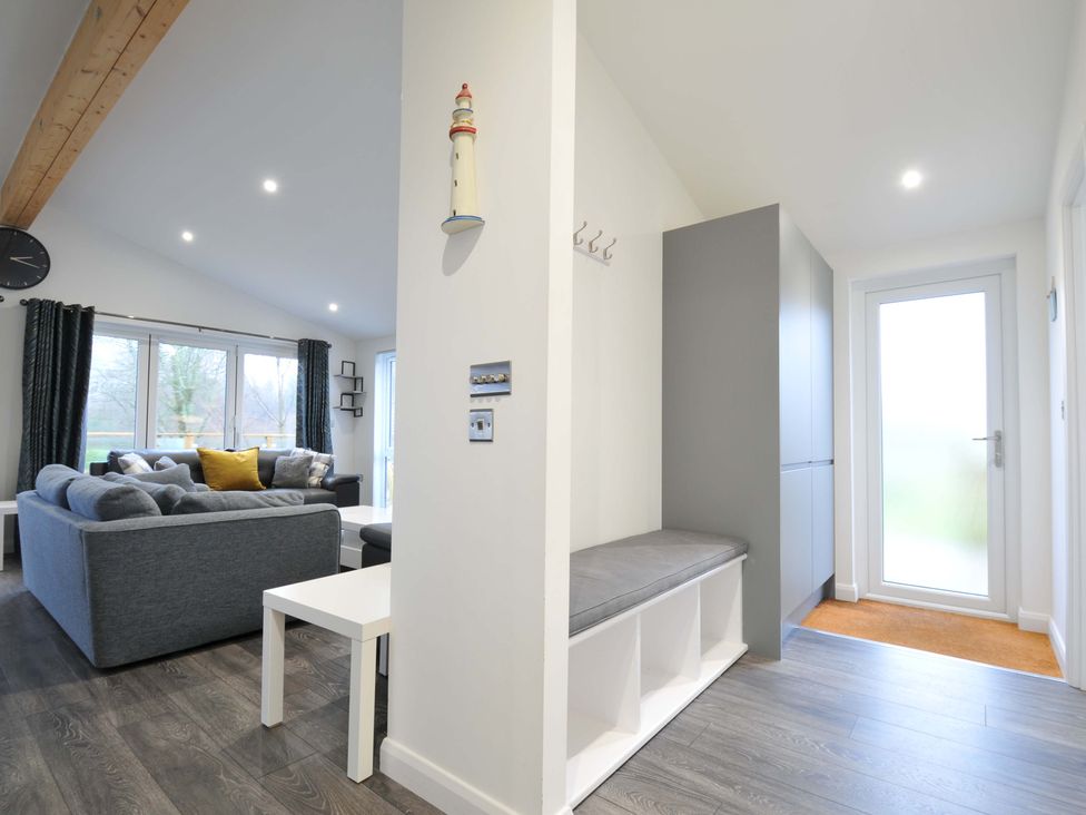A living room with a sofa and coffee table at 20 Meadow Retreat in Dobwalls