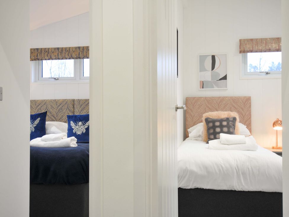 A bedroom with two beds and decorative pillows at 20 Meadow Retreat in Dobwalls