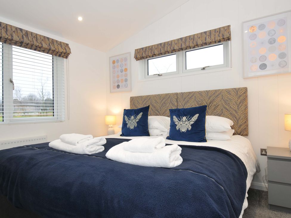 A bedroom with a bed and decorative pillows at 20 Meadow Retreat in Dobwalls