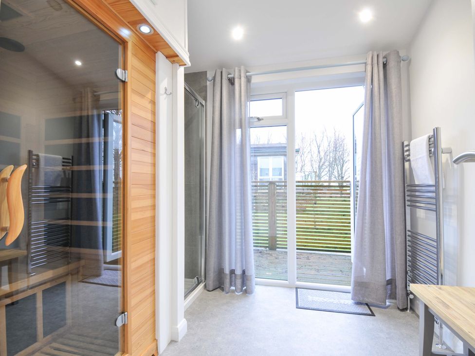 A bathroom with a sauna and shower at 20 Meadow Retreat in Dobwalls