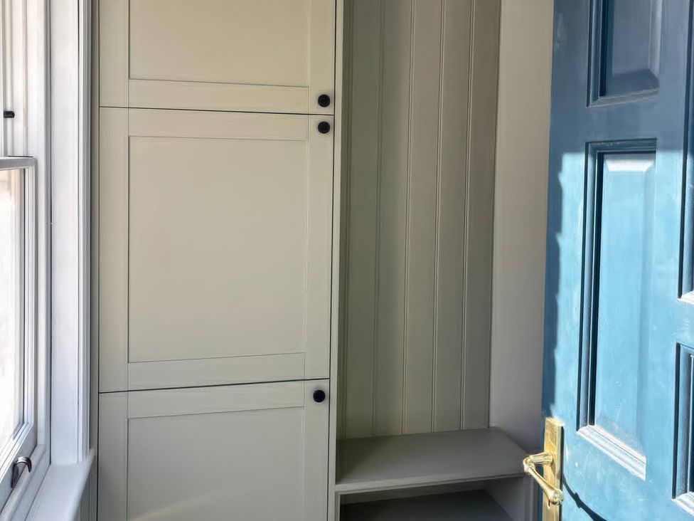 A closet with shelves and a window at Holt Hall - First Floor Apartment in Matlock