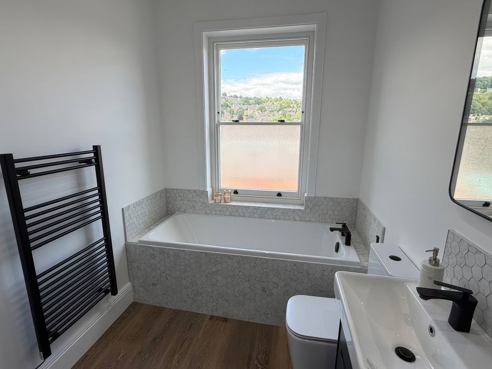 A bathroom featuring a bathtub, toilet, and sink at Holt Hall - First Floor Apartment Matlock