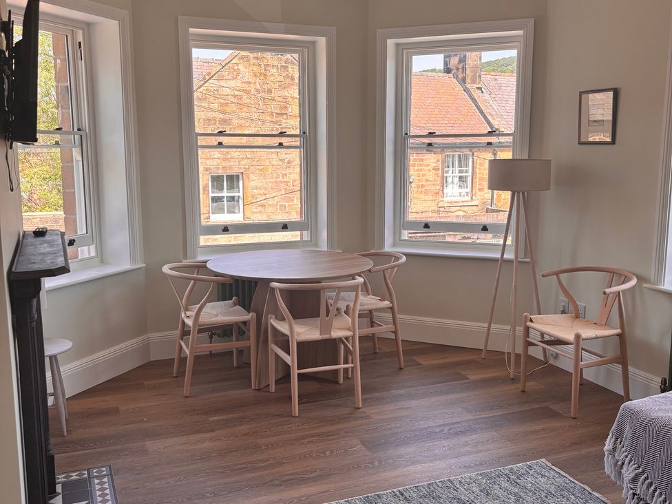 A dining room with a table and chairs at Holt Hall - First Floor Apartment in Matlock