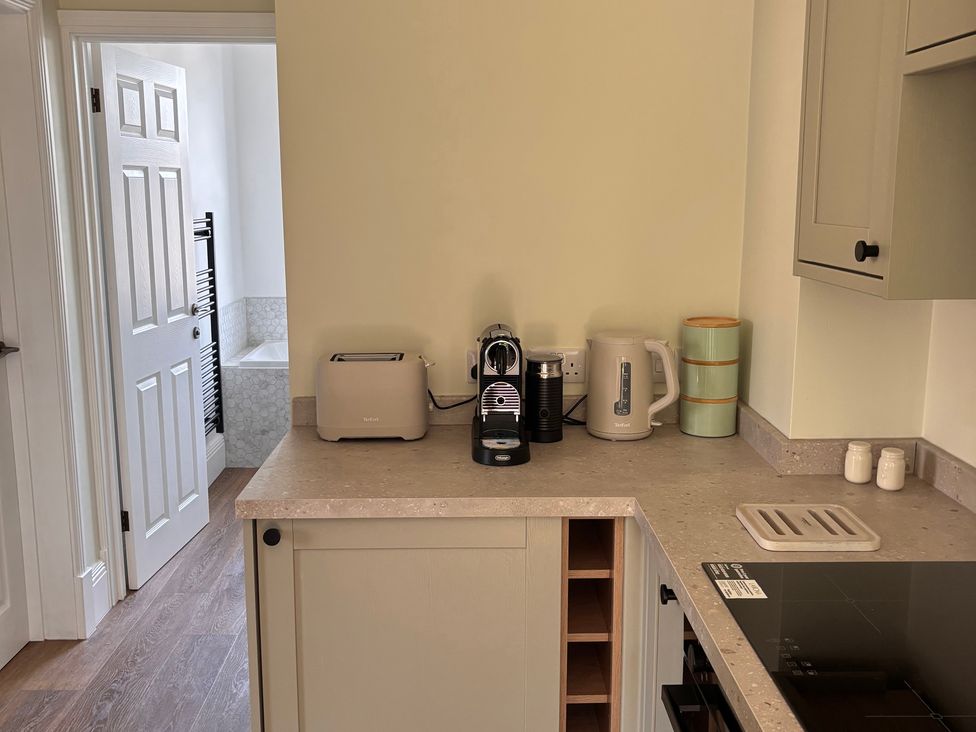 A kitchen with appliances and countertop at Holt Hall - First Floor Apartment Matlock