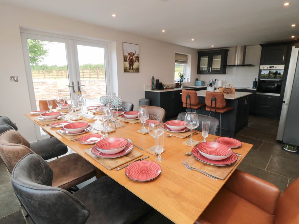A dining room with a table set for meals at Westholme Lodge in Thirsk