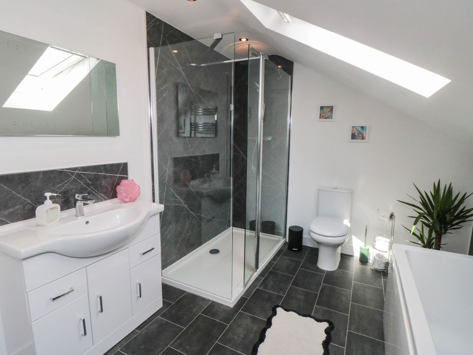 A bathroom with a shower and bathtub at Westholme Lodge in Thirsk