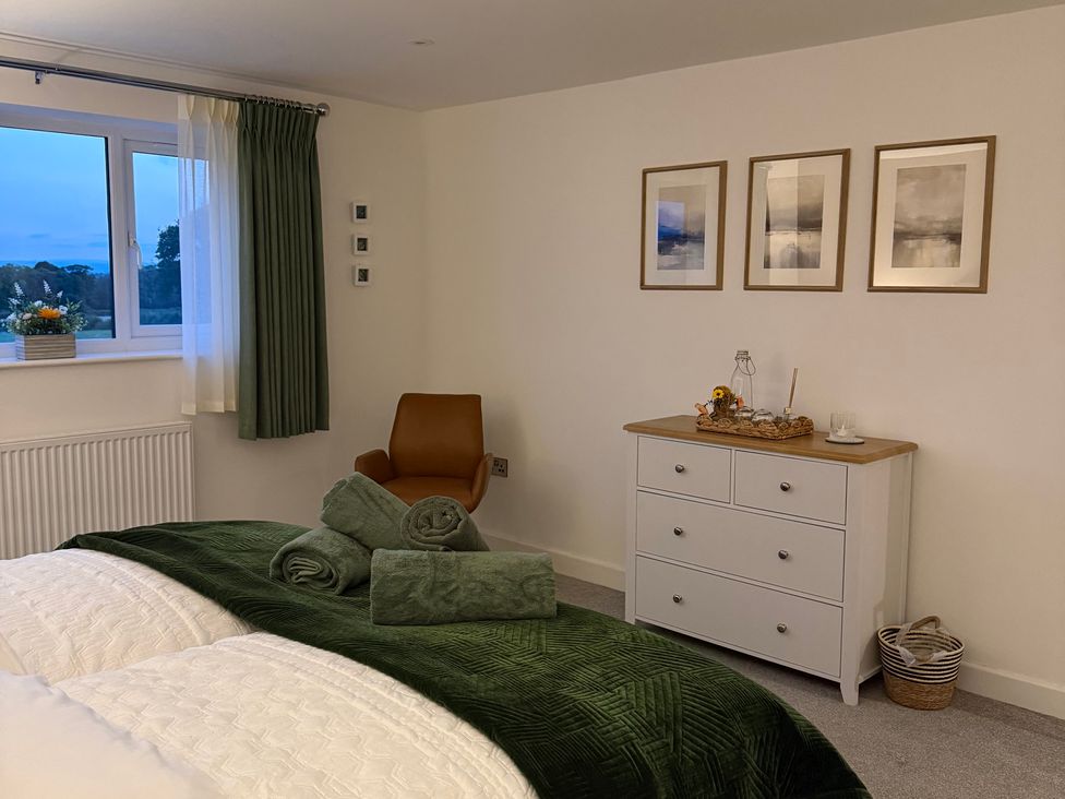 A bedroom with a bed and dresser at Westholme Country Lodge in Thirsk