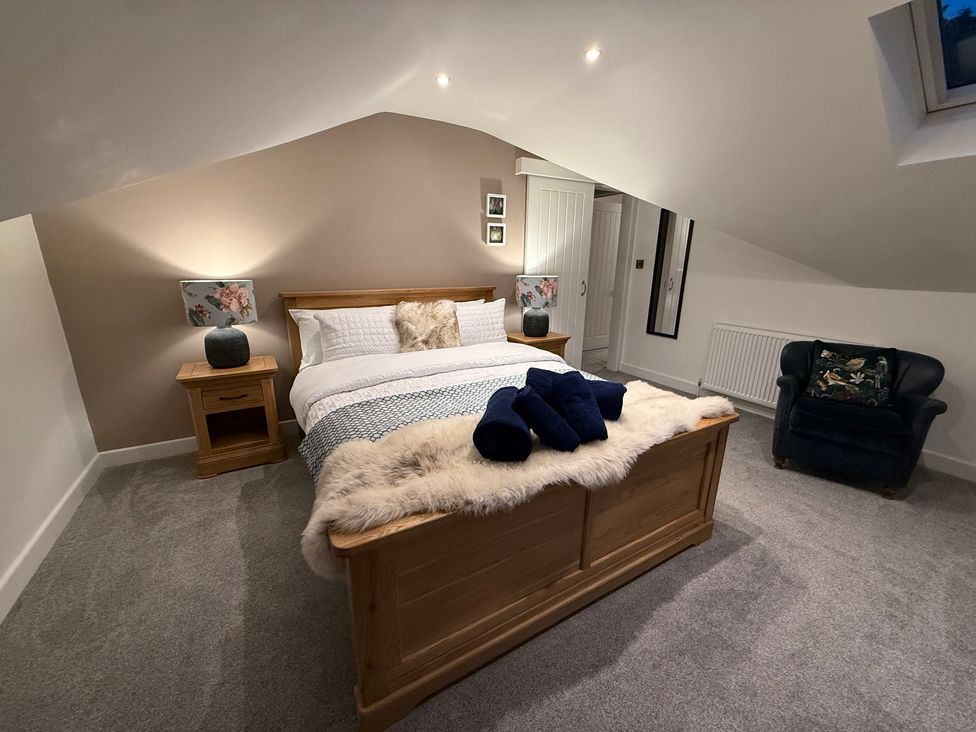 A bedroom with a bed and bedside table at Westholme Country Lodge in Thirsk