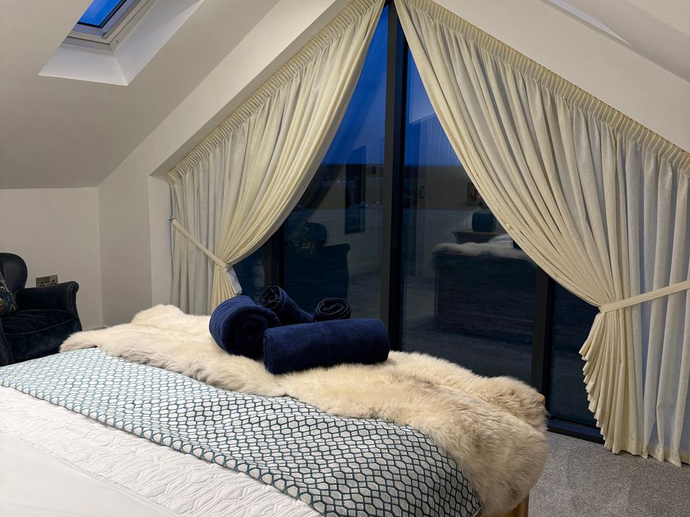 A bedroom with a bed and curtains at Westholme Country Lodge in Thirsk