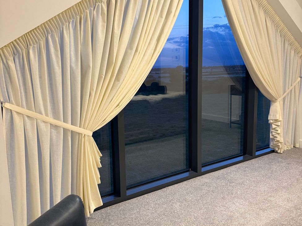 A living room with curtains and a window at Westholme Country Lodge in Thirsk