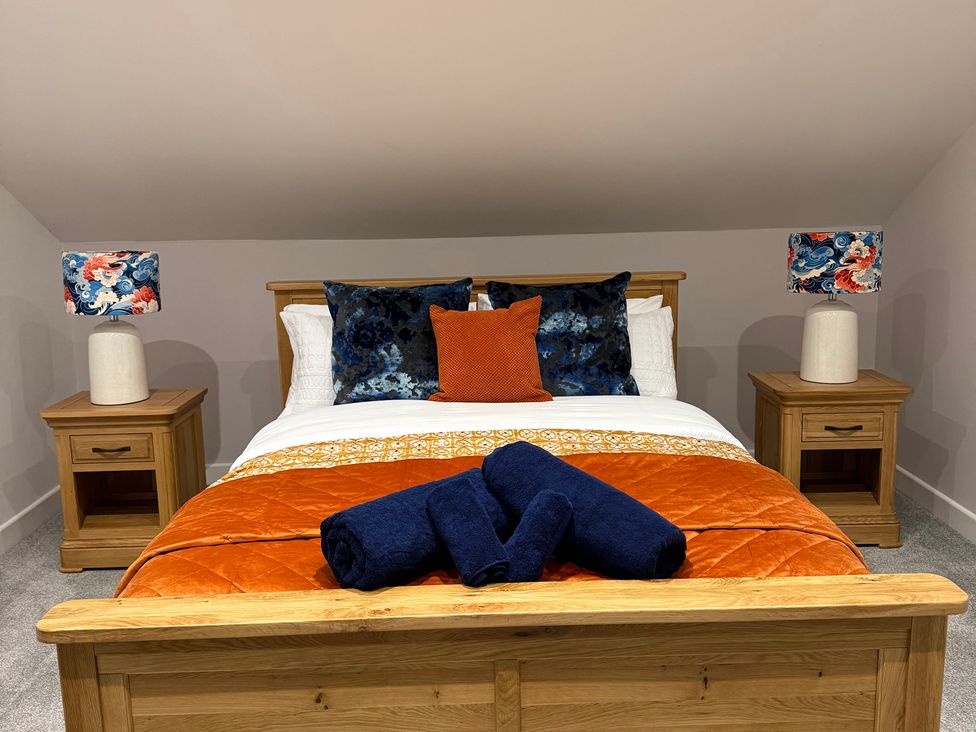A bedroom with a bed and bedside tables at Westholme Country Lodge Thirsk