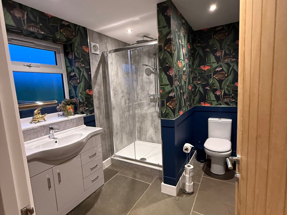 A bathroom with a shower, sink, and toilet at Westholme Country Lodge in Thirsk