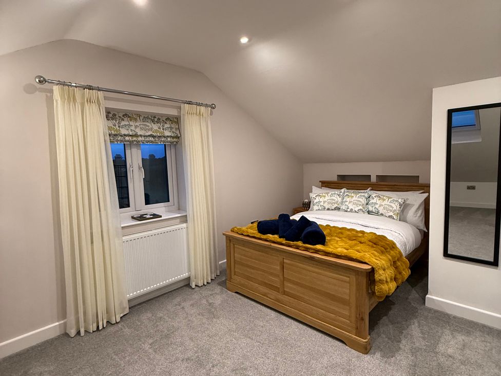 A bedroom with a bed and a window at Westholme Country Lodge in Thirsk