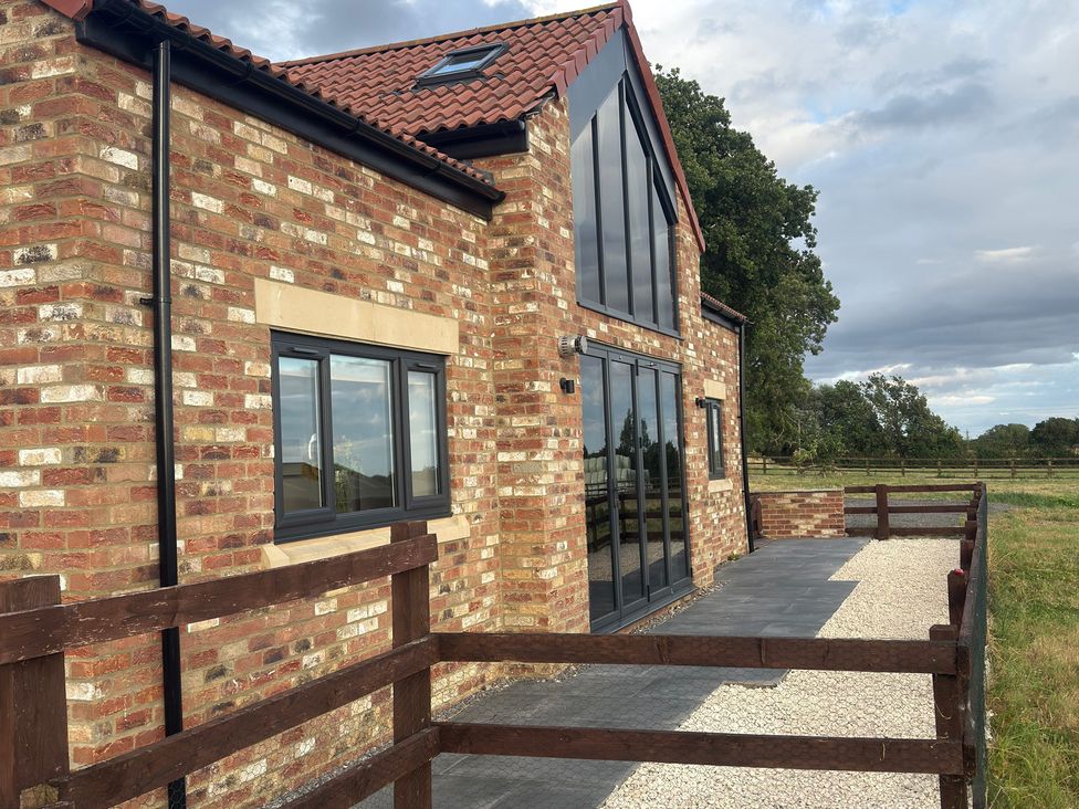 A house with windows and a patio at Westholme Country Lodge Thirsk