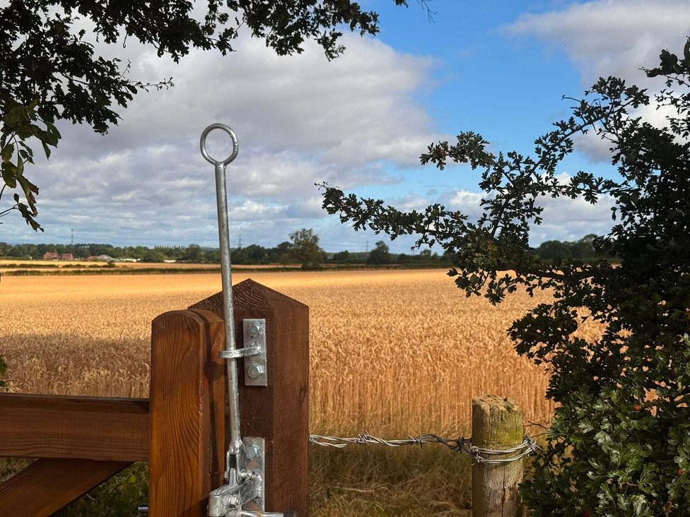 A field with a gate and trees at Westholme Country Lodge in Thirsk