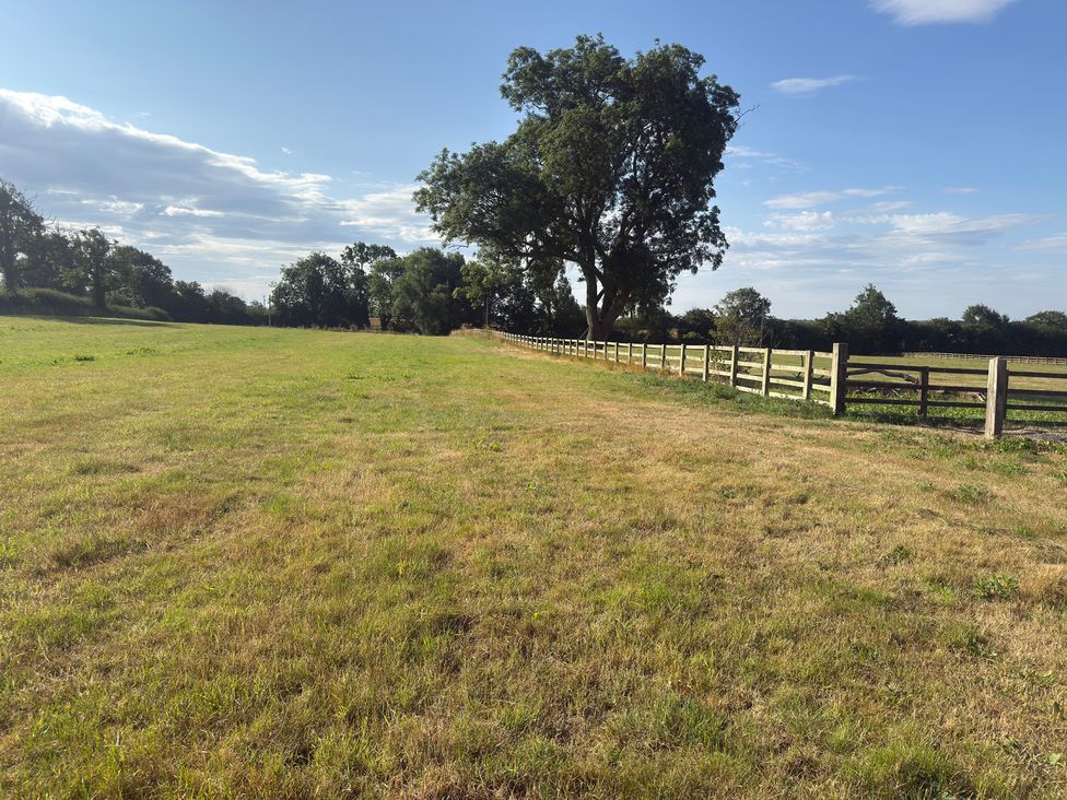An outdoor area with grass and a fence at Westholme Country Lodge Thirsk