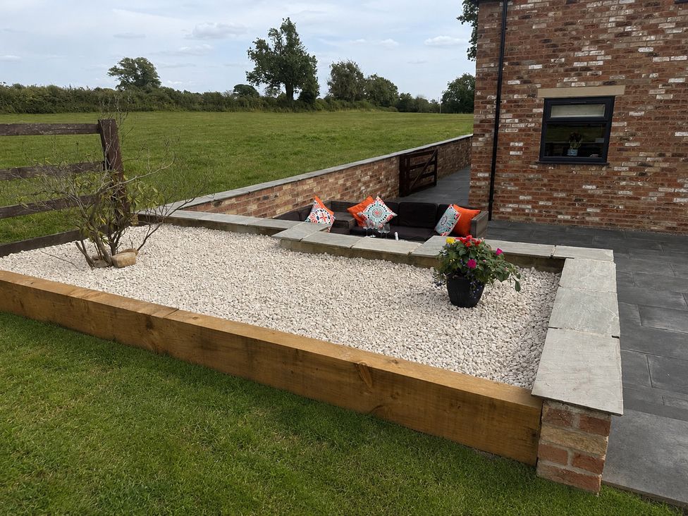 An outdoor area with a gravel bed and seating at Westholme Country Lodge Thirsk
