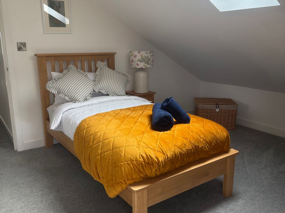 A bedroom with a bed and lamp at Westholme Country Lodge in Thirsk