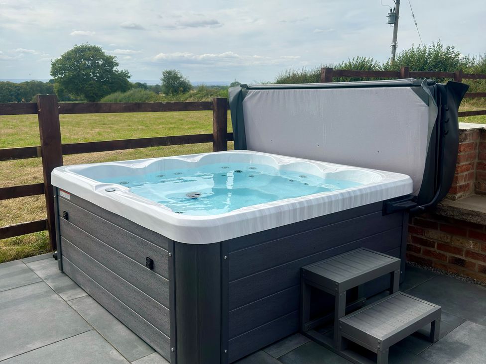 A hot tub with steps in an outdoor area at Westholme Country Lodge Thirsk
