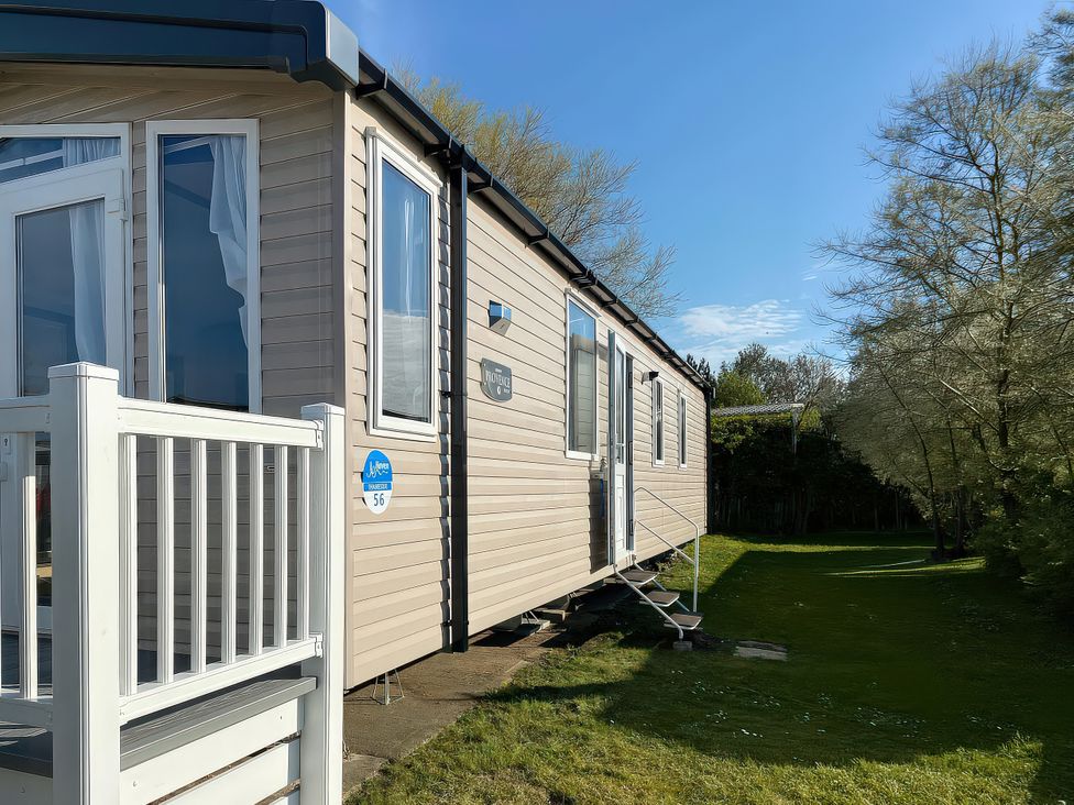A mobile home with steps leading to a deck at Thameside in Allhallows