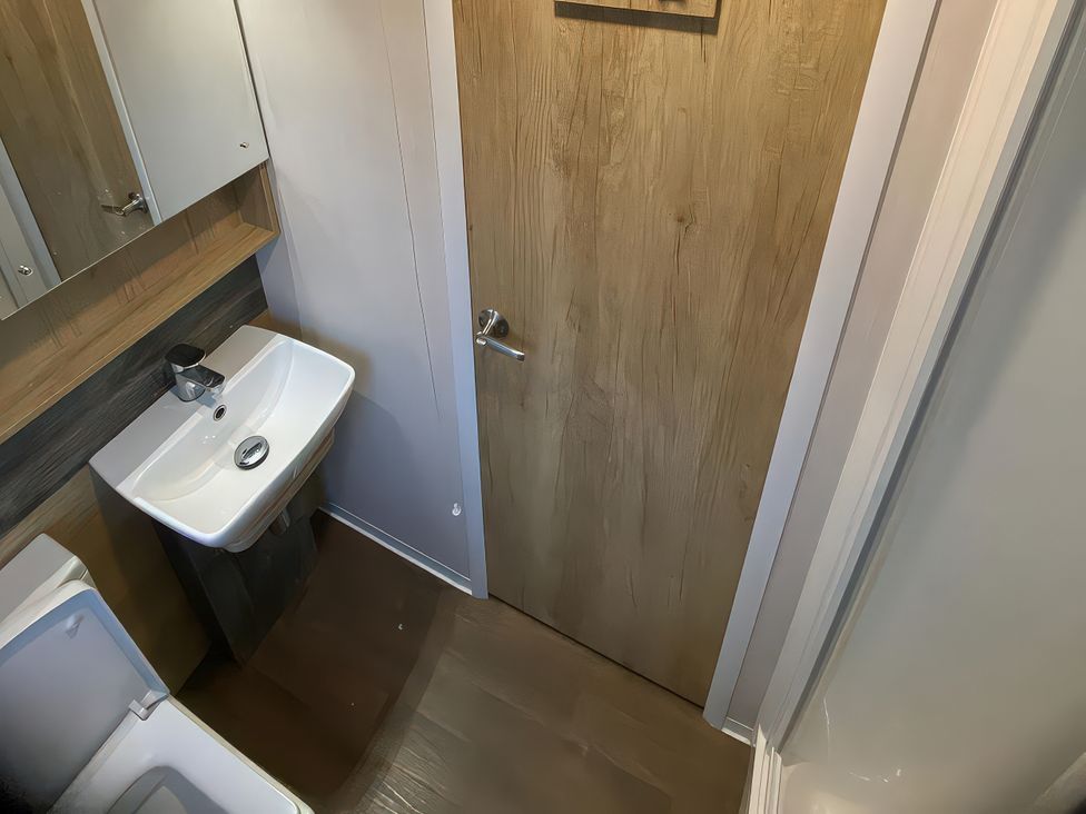 A bathroom with a sink and a toilet at Thameside in Allhallows