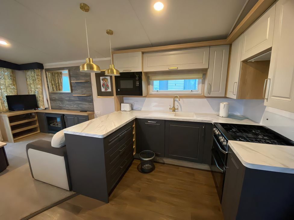 A kitchen with cabinets and appliances at Thameside in Allhallows