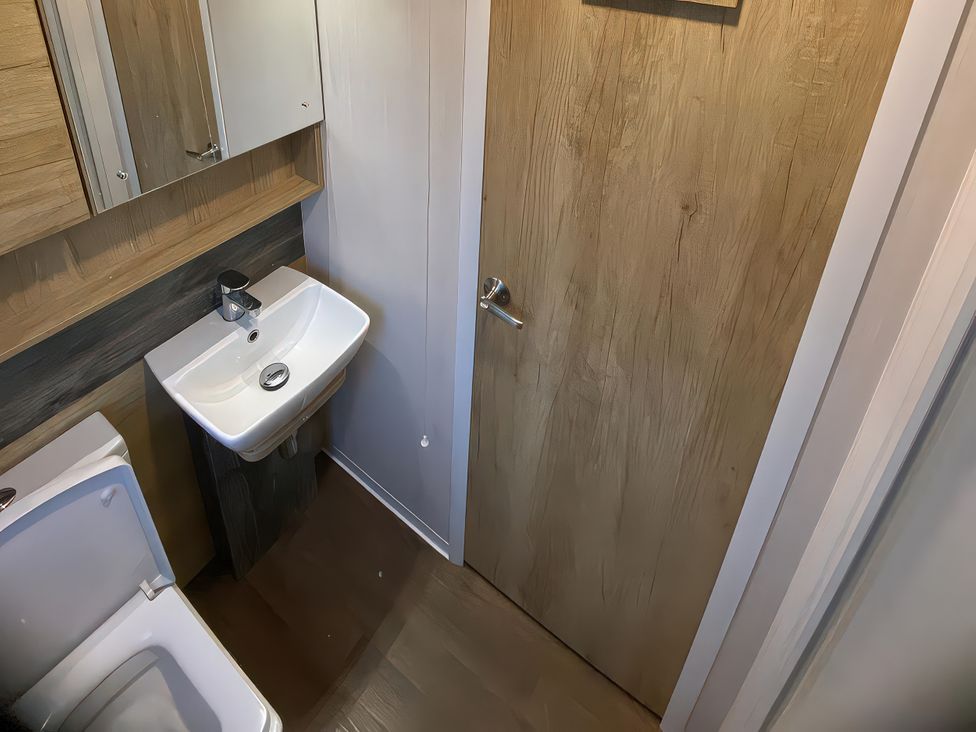 A bathroom with a sink and a toilet at Thameside in Allhallows