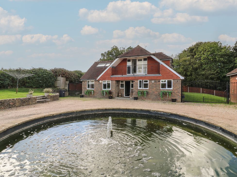 A house with a garden and fountain at Panel Place near Pett