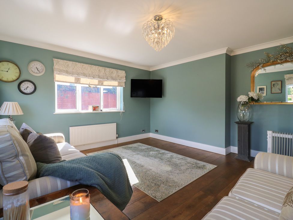A living room with a television and sofa at Panel Place near Pett