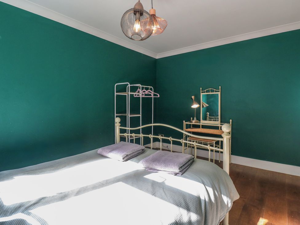 A bedroom with a bed and furniture at Panel Place near Pett