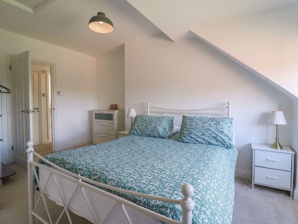 A bedroom with a bed and dresser at Panel Place near Pett