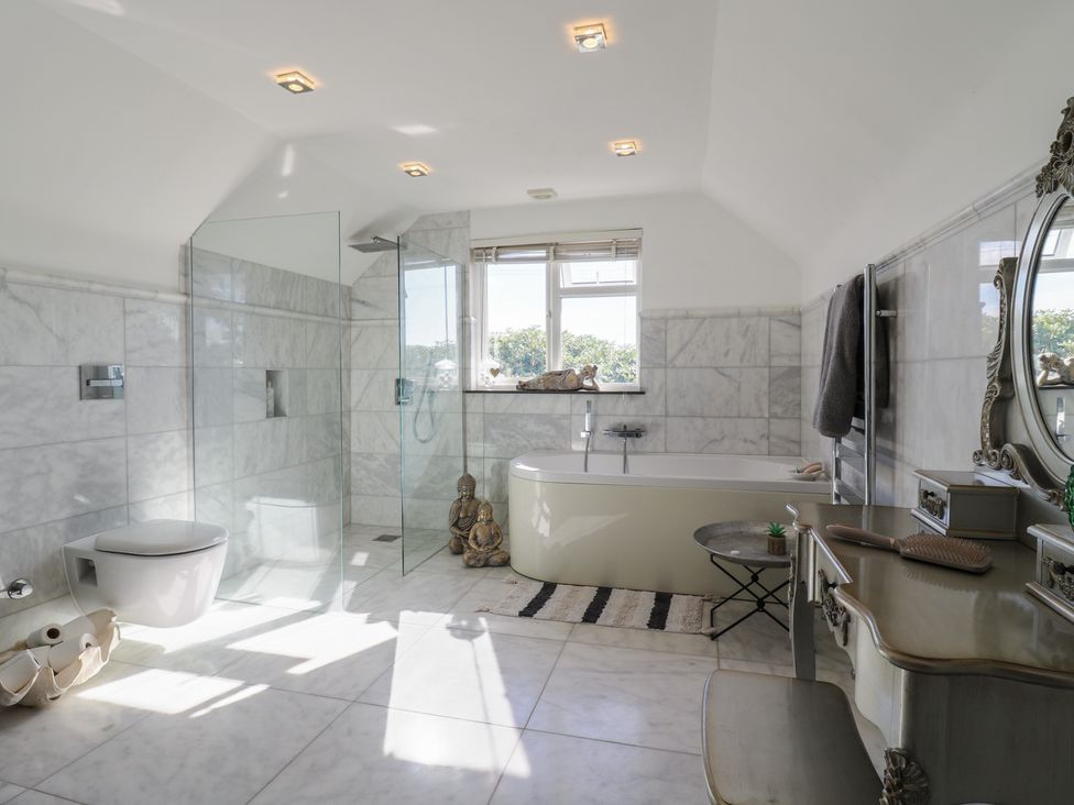 A bathroom with a bathtub and shower at Panel Place near Pett
