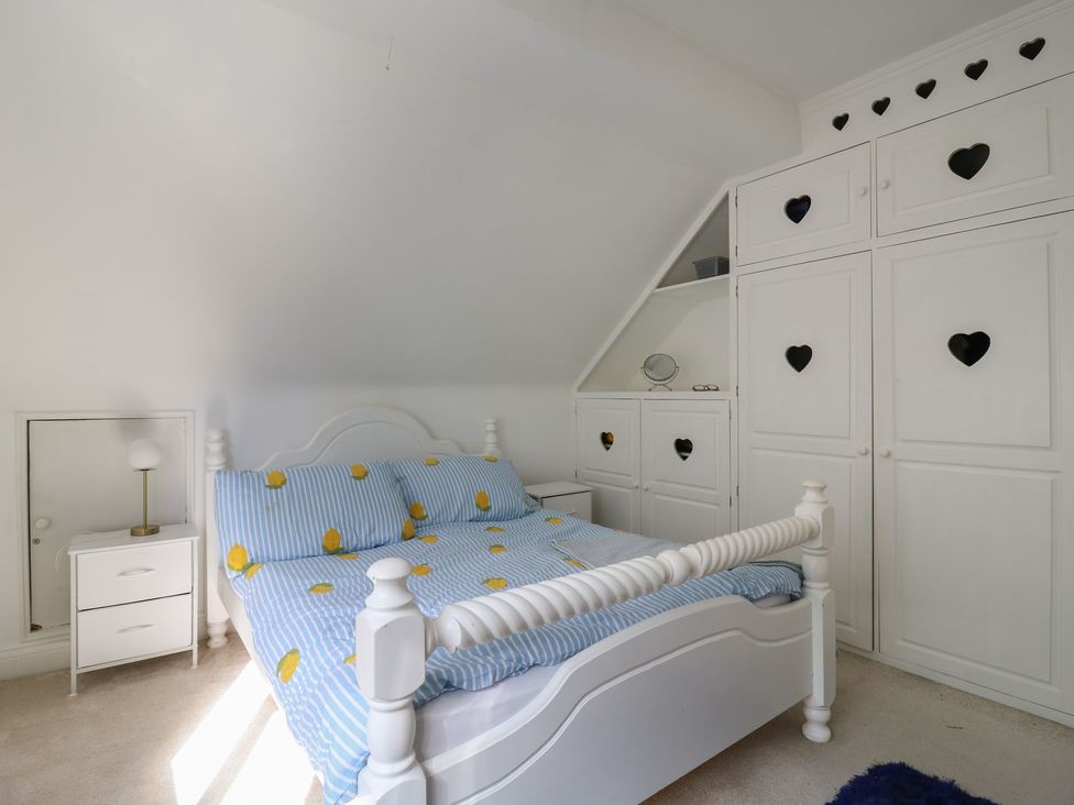 A bedroom with a bed and wardrobe at Panel Place near Pett